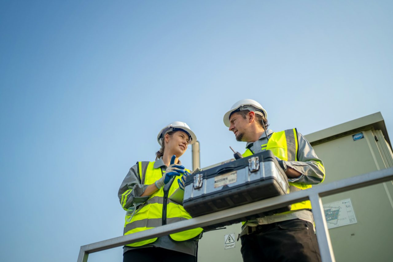 Engineers inspecting outdoor diesel generator – reliable power solutions in Zirakpur by KJM Genset Solutions