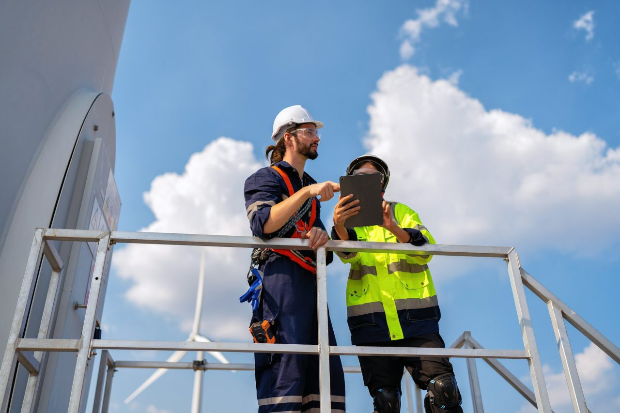 Technicians working on solar energy setup – sustainable power mission of KJM Genset Solutions